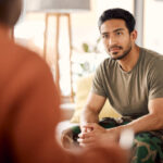 two seated people talking face-to-face