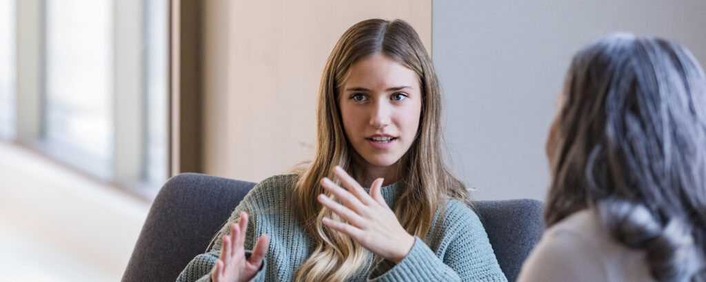 young woman speaks with therapist