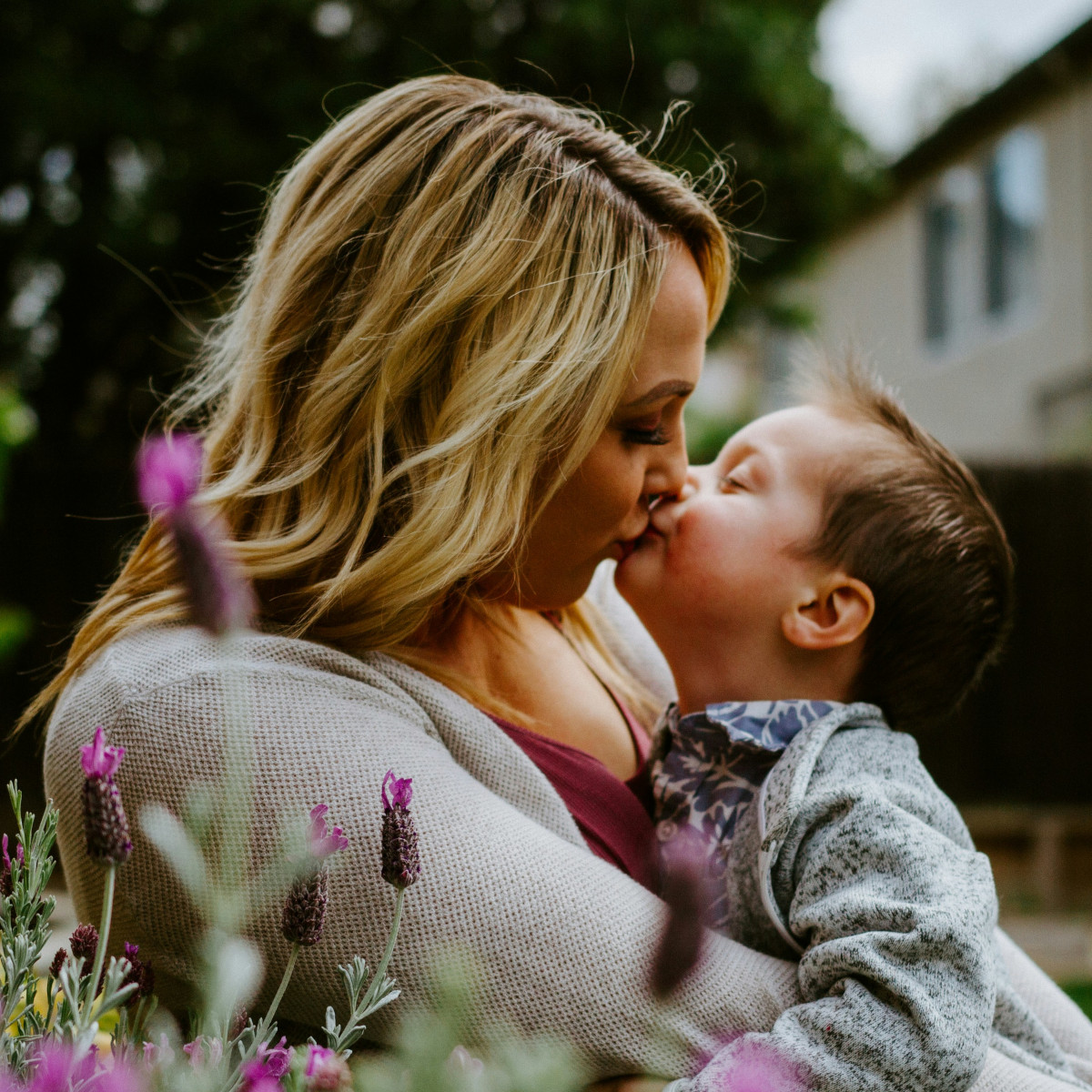 mother kissing toddler